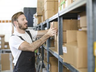 Warehouse worker stacking boxes